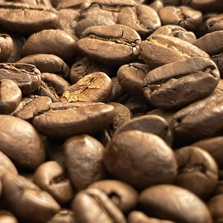 Close-up of Guatemalan coffee beans, showcasing their rich colour and robust texture. Guatemalan coffee beans are known for their exceptional quality and distinct flavour profile, featuring bold notes of chocolate, caramel, and hints of citrus. Indulge in the rich and complex flavours of Guatemala with every sip. #GuatemalanCoffee #CoffeeBeans #RichFlavour