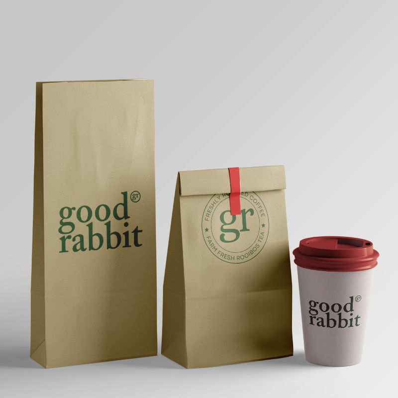 Two craft pouches filled with Rooibos Loose Leaf tea, accompanied by a disposable cardboard cup with a plastic lid